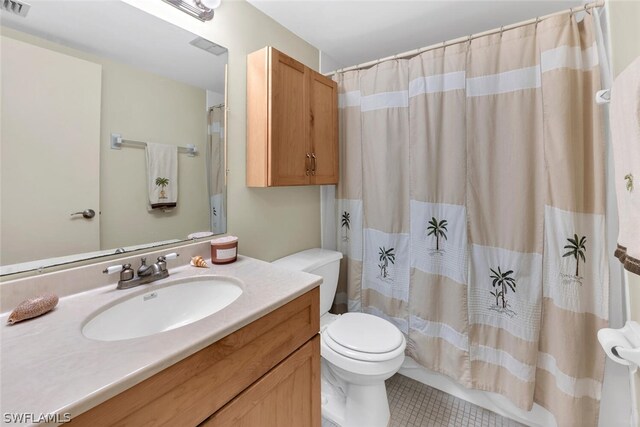 bathroom featuring a shower with curtain, vanity, tile patterned flooring, and toilet