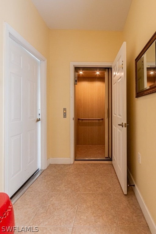 hall featuring light tile patterned flooring