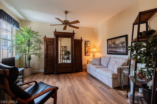 living room featuring ceiling fan and wood-type flooring