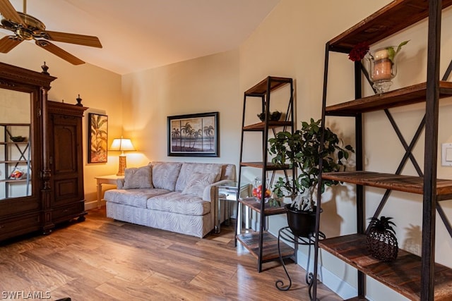 living room with vaulted ceiling, hardwood / wood-style floors, and ceiling fan