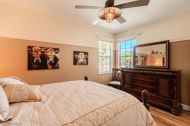 bedroom featuring light hardwood / wood-style floors and ceiling fan