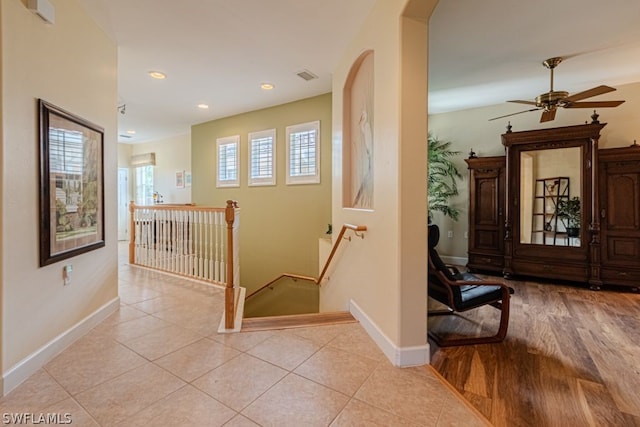 hallway with light hardwood / wood-style floors