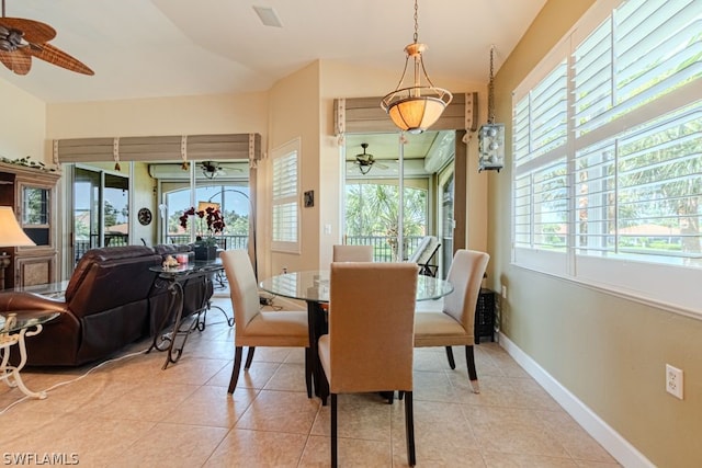 tiled dining area with ceiling fan and a wealth of natural light