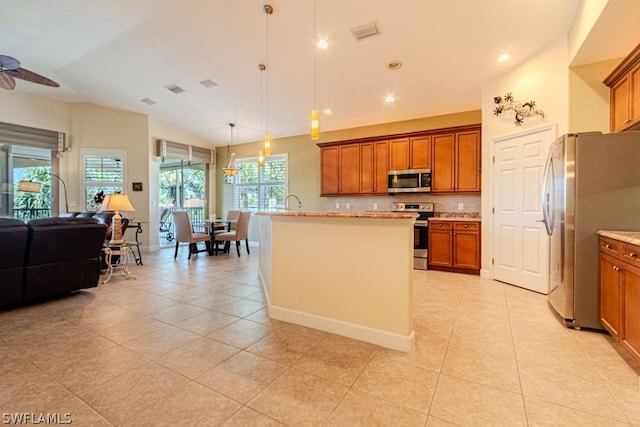 kitchen featuring stainless steel appliances, pendant lighting, backsplash, ceiling fan with notable chandelier, and light tile patterned flooring