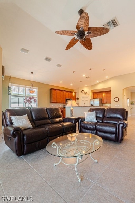 tiled living room with ceiling fan