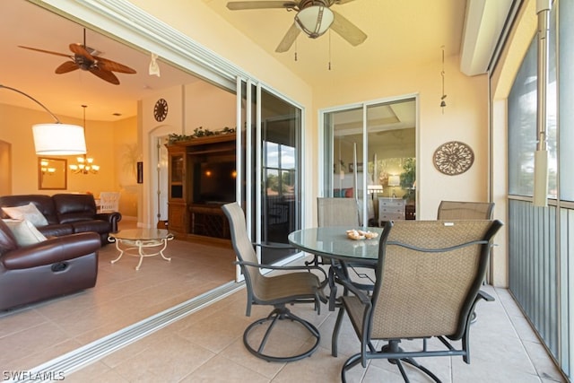 sunroom / solarium featuring ceiling fan