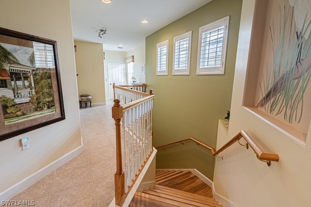 staircase featuring light tile patterned flooring