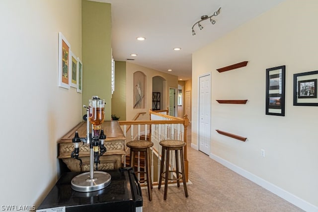 carpeted dining room featuring track lighting