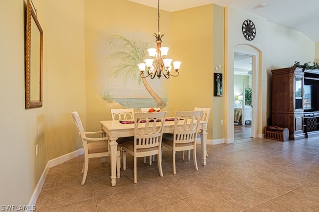 dining space featuring light tile patterned flooring and a chandelier