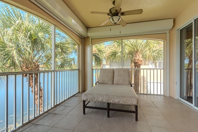 sunroom featuring ceiling fan