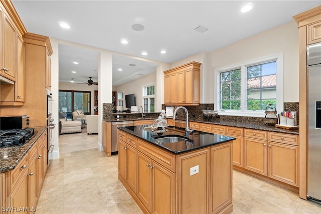 kitchen featuring sink, a center island with sink, dishwasher, kitchen peninsula, and black gas cooktop