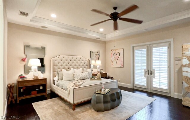 bedroom featuring dark wood-type flooring, ceiling fan, access to exterior, ornamental molding, and a raised ceiling