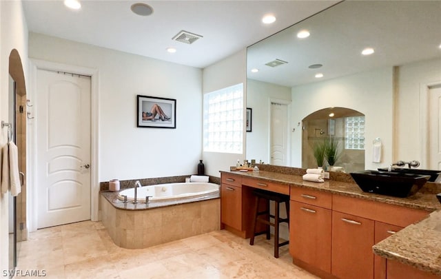 bathroom featuring vanity and shower with separate bathtub