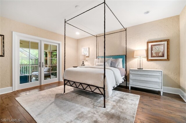 bedroom featuring dark wood-type flooring, access to outside, and french doors