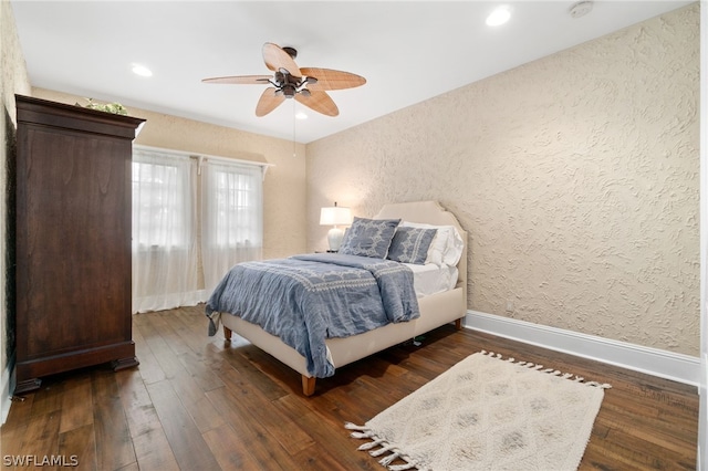 bedroom featuring dark wood-type flooring and ceiling fan