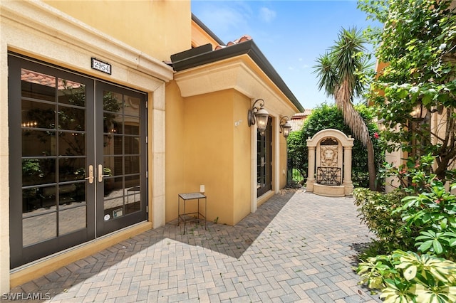 property entrance with a patio and french doors