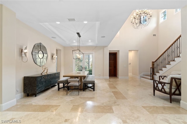 dining room featuring a raised ceiling and a chandelier