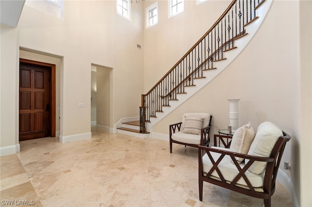 foyer with a towering ceiling