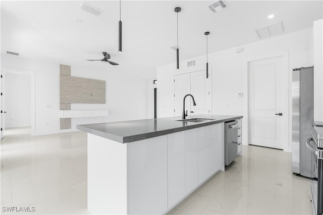 kitchen featuring white cabinets, sink, hanging light fixtures, ceiling fan, and stainless steel appliances