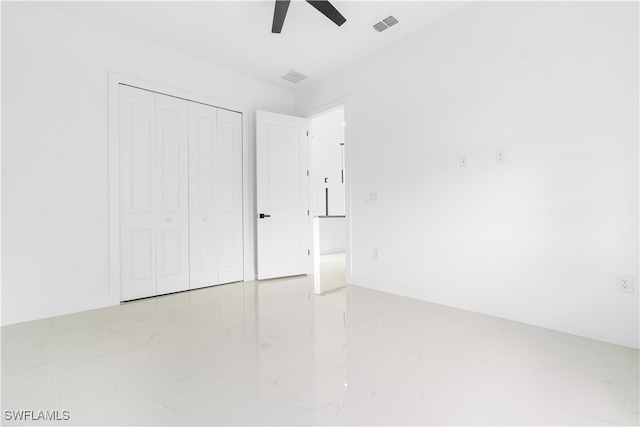 unfurnished bedroom with a closet and ceiling fan