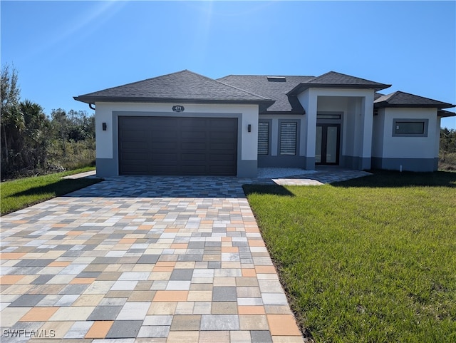 view of front of property with a front yard and a garage