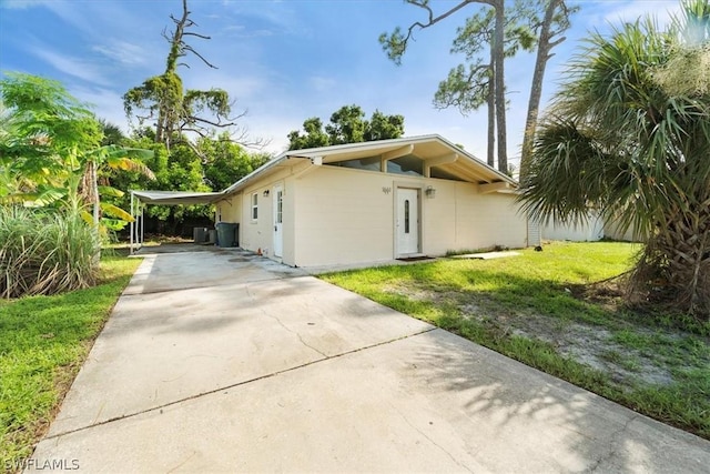 view of side of property with a yard and a carport