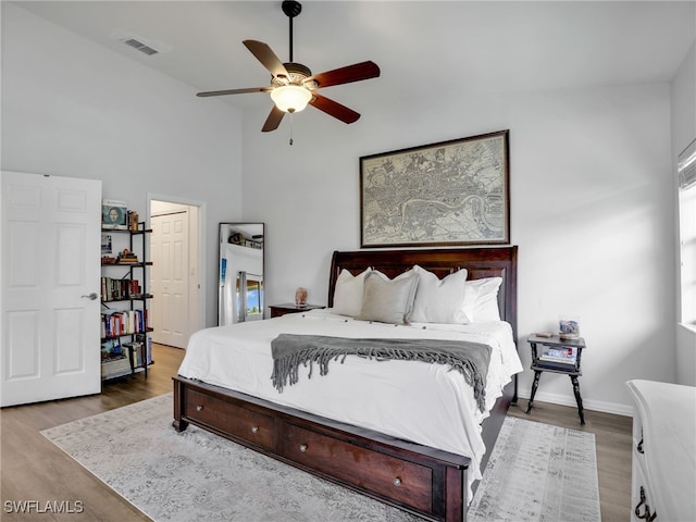 bedroom featuring high vaulted ceiling, ceiling fan, and hardwood / wood-style floors