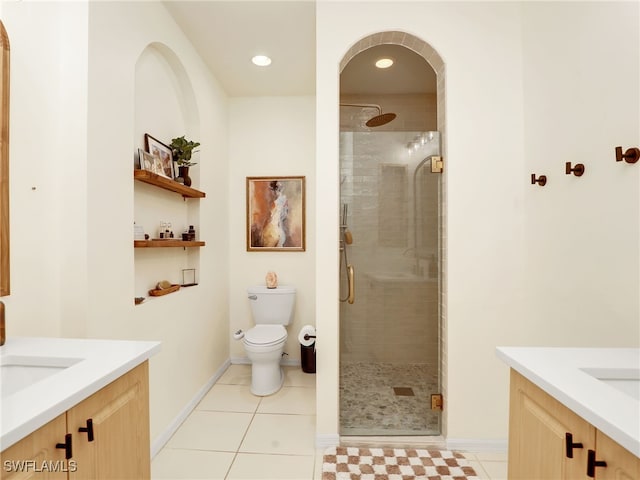 bathroom with tile patterned flooring, a shower with shower door, toilet, and vanity