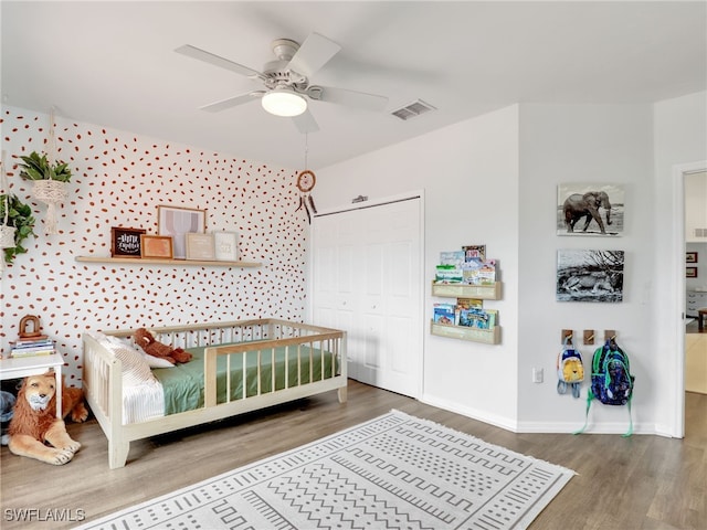 bedroom featuring a closet, hardwood / wood-style floors, and ceiling fan