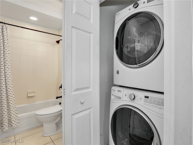 washroom featuring light tile patterned floors and stacked washer / drying machine