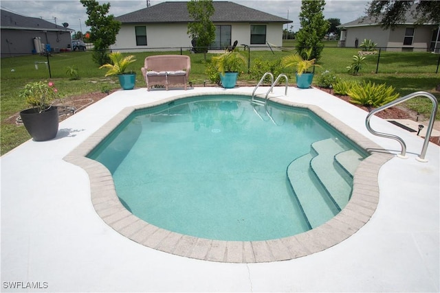 view of pool with a yard