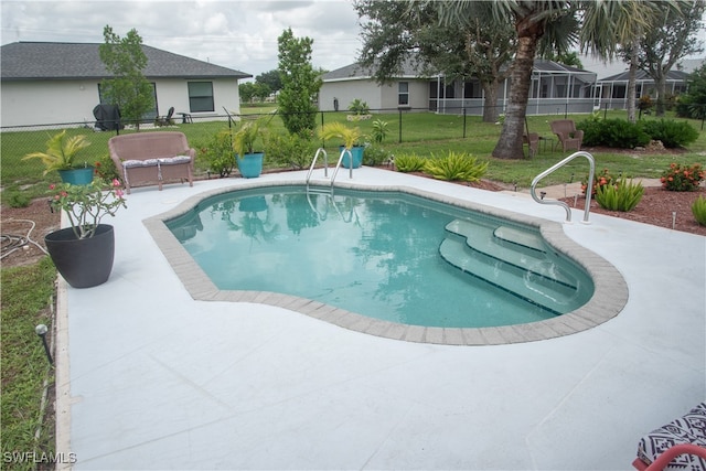 view of pool featuring a patio area and a yard