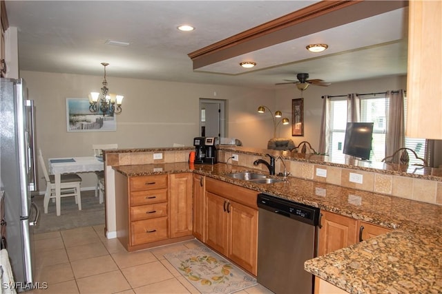 kitchen featuring sink, kitchen peninsula, pendant lighting, ceiling fan with notable chandelier, and appliances with stainless steel finishes