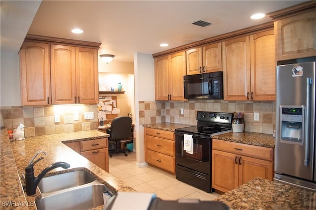 kitchen featuring light stone countertops, sink, decorative backsplash, light tile patterned floors, and black appliances