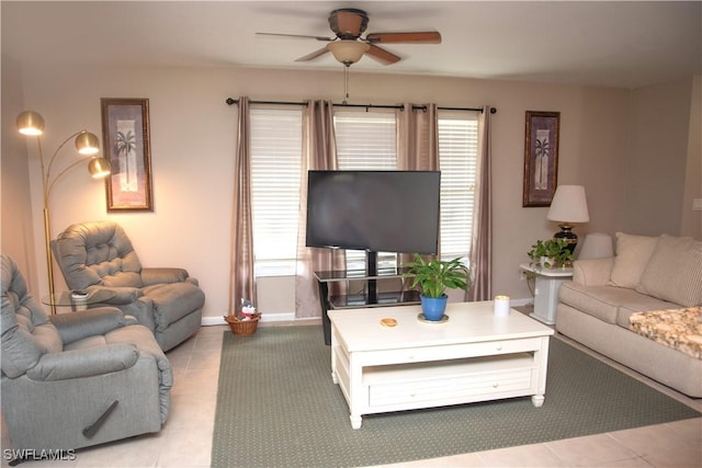 living room with ceiling fan, plenty of natural light, and light tile patterned floors