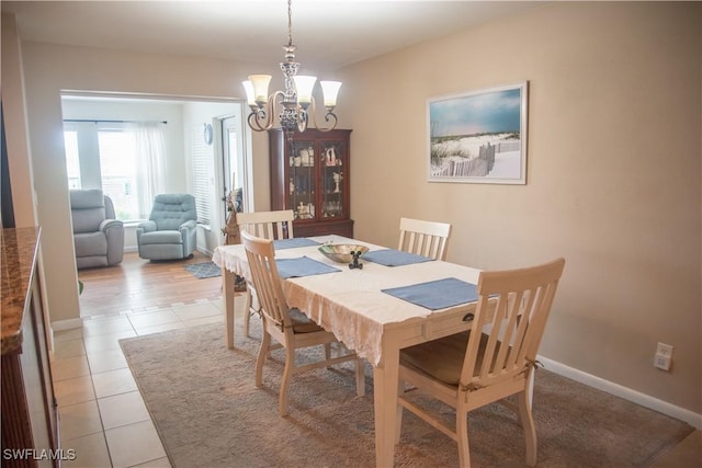 dining room featuring light tile patterned floors and an inviting chandelier