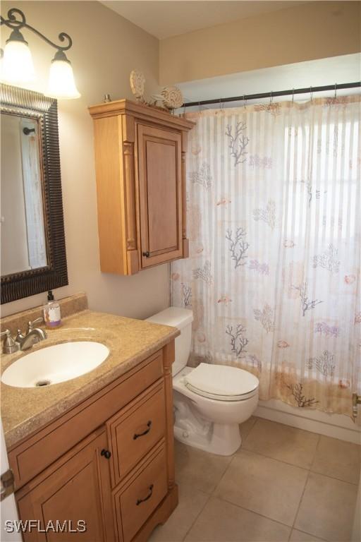 full bathroom with tile patterned floors, vanity, toilet, and shower / tub combo