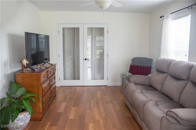 living room with french doors, dark hardwood / wood-style flooring, and ceiling fan