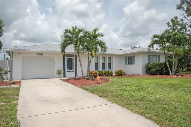 single story home featuring a front lawn and a garage