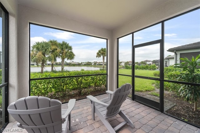 sunroom / solarium with a water view