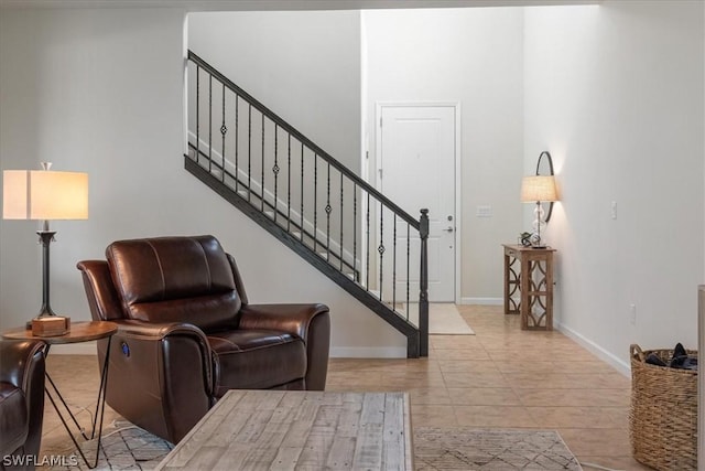 interior space with stairway and baseboards