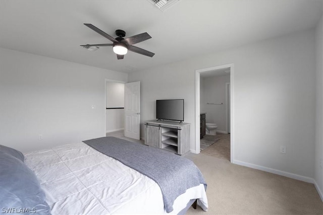 bedroom with light carpet, visible vents, baseboards, and ensuite bathroom