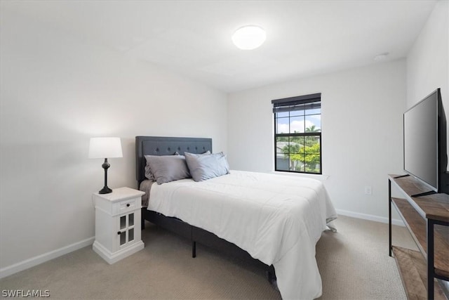 bedroom with baseboards and carpet flooring