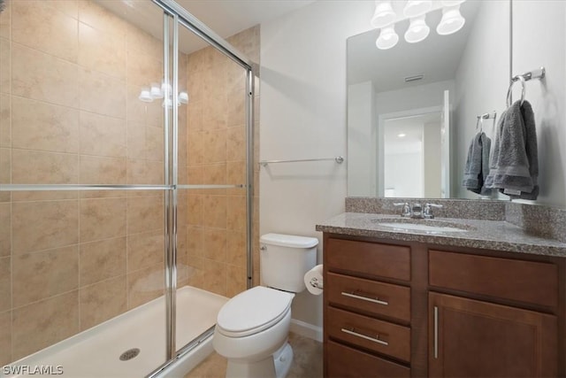 full bathroom featuring toilet, a shower stall, and vanity