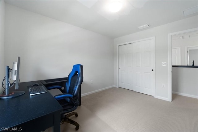 carpeted office featuring visible vents and baseboards