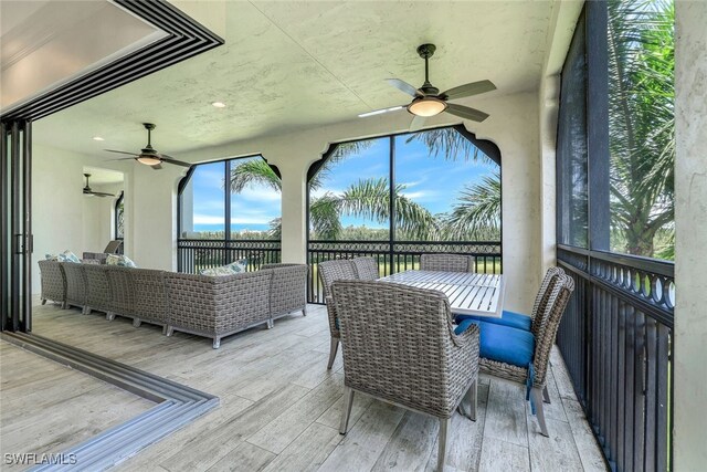 deck featuring ceiling fan and an outdoor hangout area