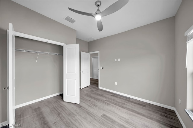 unfurnished bedroom with a closet, ceiling fan, and hardwood / wood-style floors