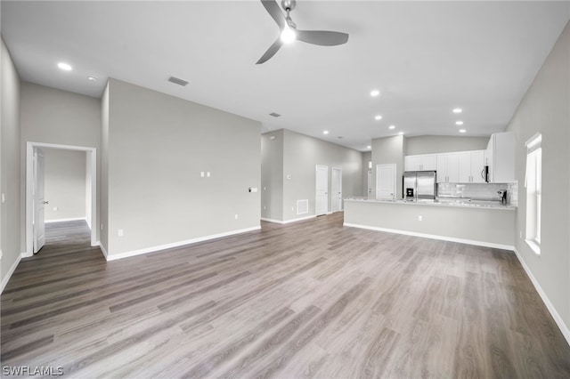 unfurnished living room featuring high vaulted ceiling, ceiling fan, and hardwood / wood-style floors