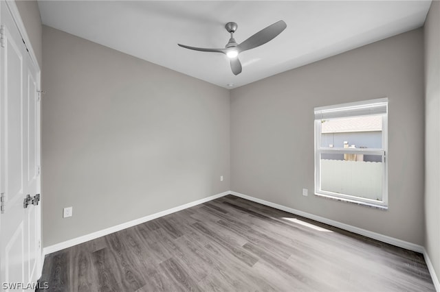 unfurnished room with ceiling fan and hardwood / wood-style floors