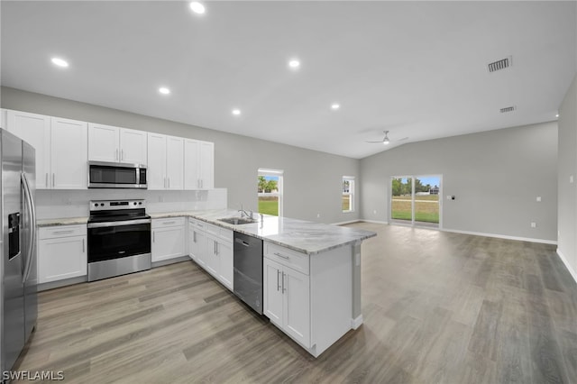 kitchen with kitchen peninsula, light hardwood / wood-style flooring, stainless steel appliances, and white cabinets